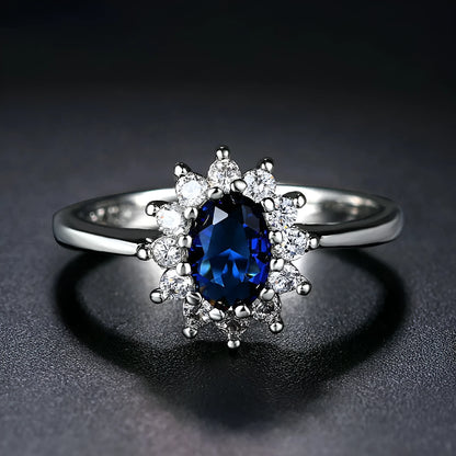A women's copper ring with a flower design and a central zirconium stone, shown in green, blue, and red colour options.