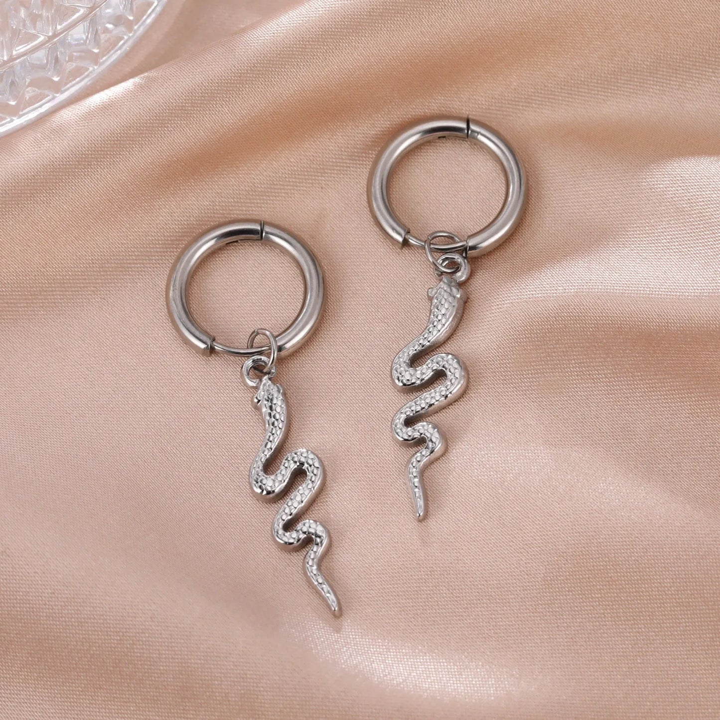 Gold coloured snake-shaped vintage clip-on earrings made from stainless steel.