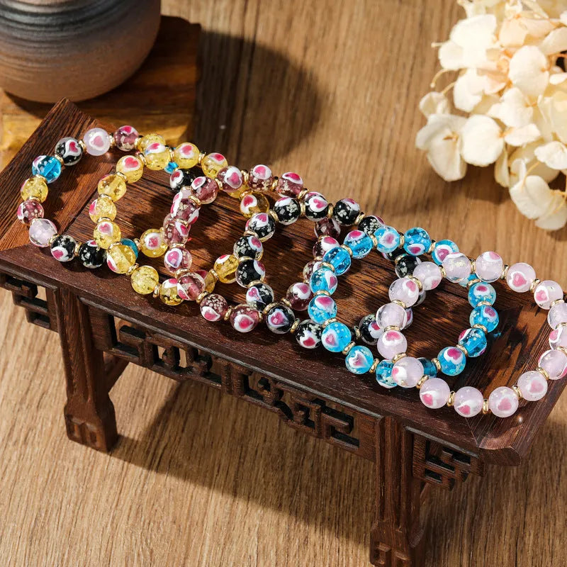 Handmade glass bracelet with 10mm swallowing gold beast cherry blossom heart charm in six colour options