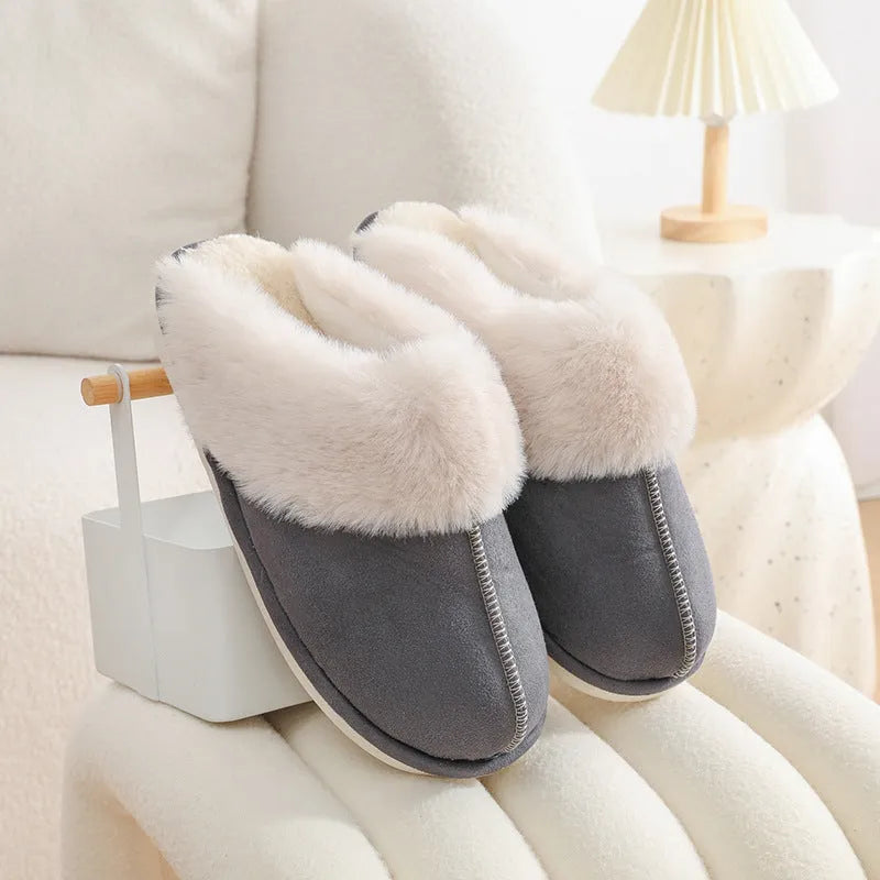 Women's plush indoor slippers in a selection of colours with a fuzzy upper and flat sole.
