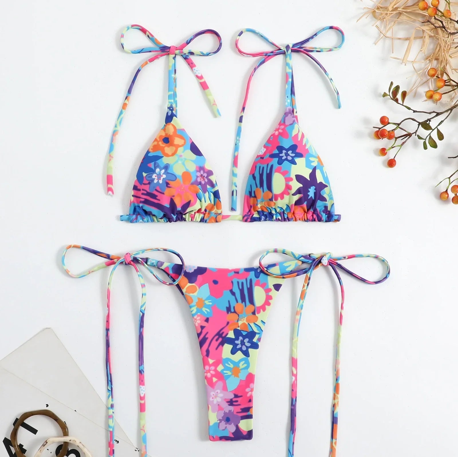 Women's split swimwear bikini set with backless design and floral pattern in available colours