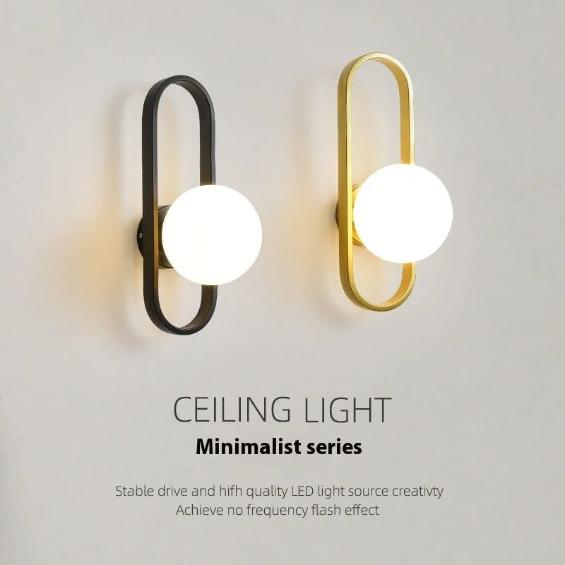 Minimalist wall lamp in black or gold finish with glass shade and 12W tri-colour LED lighting