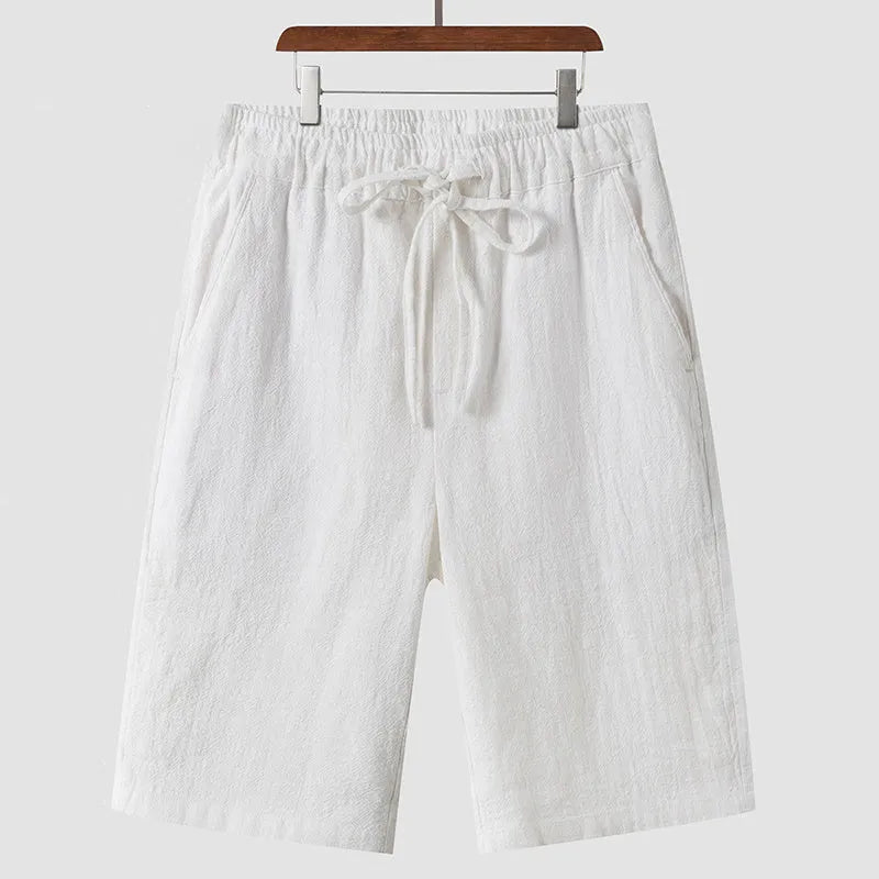 Men's linen casual shorts with elastic waistband in loose cropped design showing beige colour option