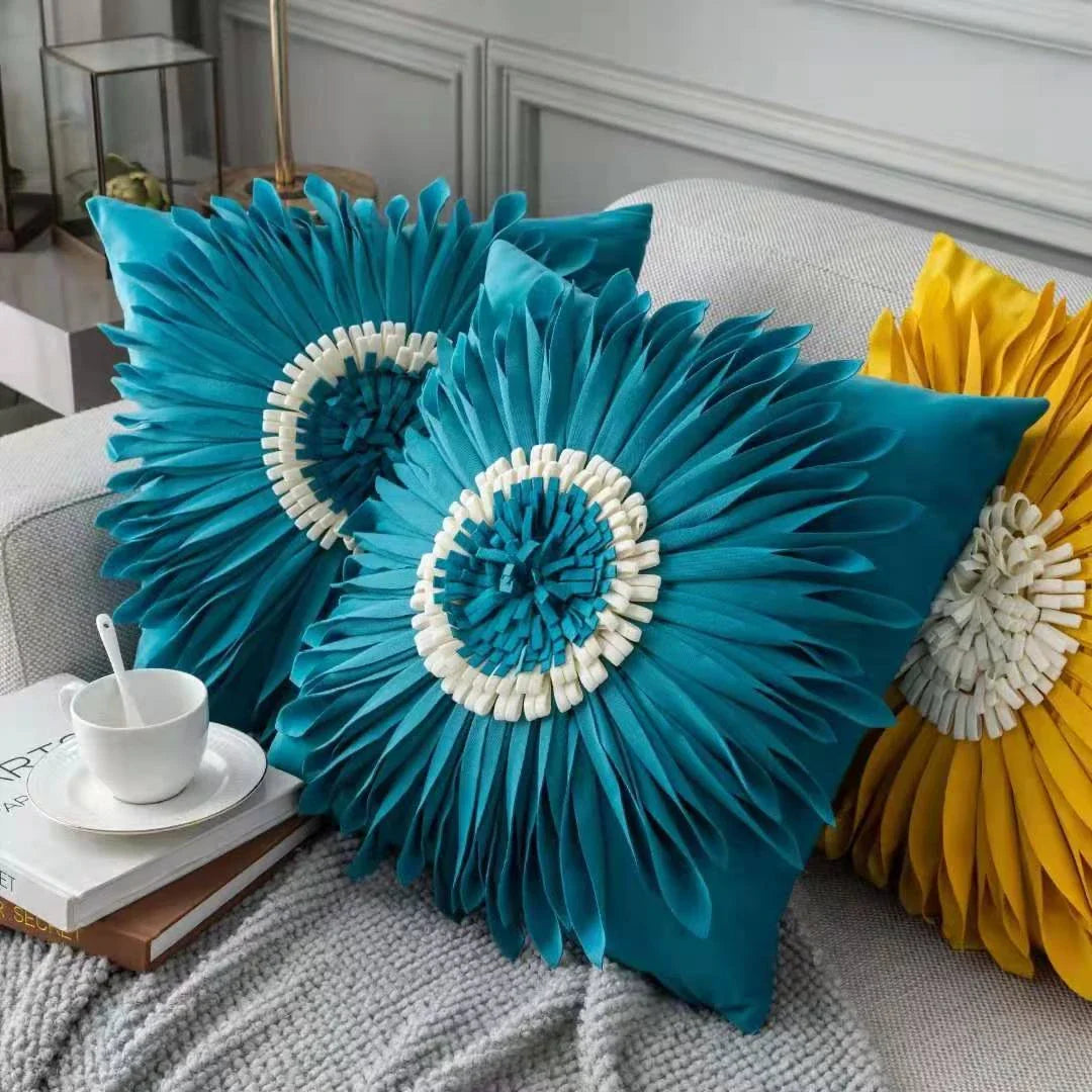 Stylish velvet throw pillows with 3D chrysanthemum embellishments in blue, yellow, pink, and white colors