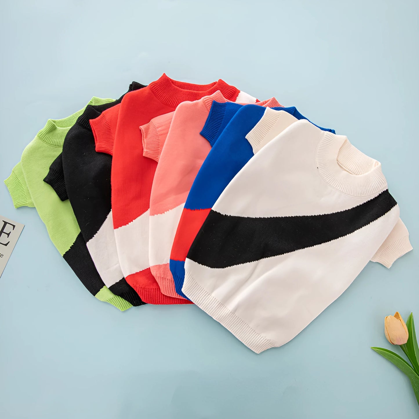 Casual wool knitted dog jumper shown in various colours including black, pink, and blue, sized for small to large breeds.