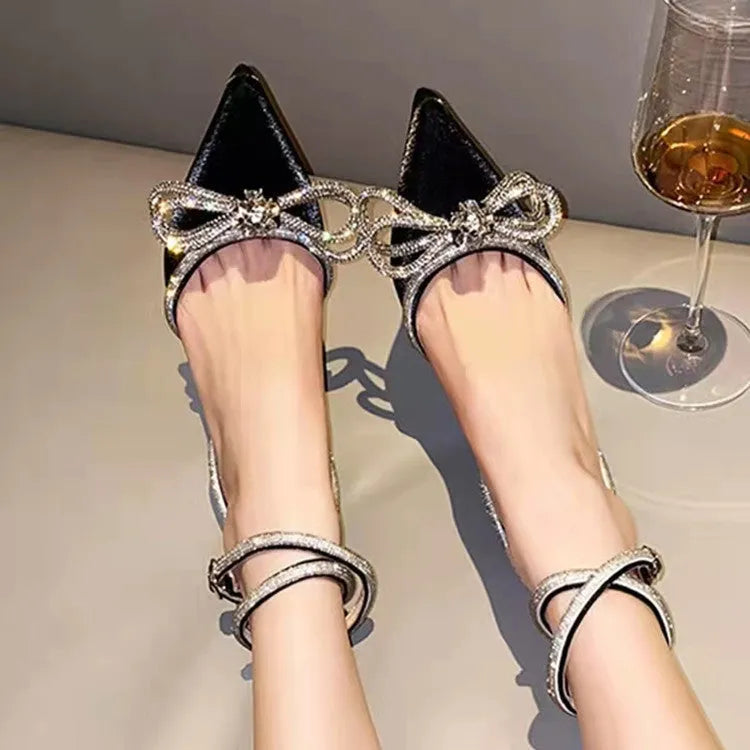 Women's black French style stiletto heel sandals with a silk back bandage and silver buckle closure.