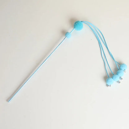 Funny cat stick toy with colourful feather tassel on elastic cord, shown in blue, pink, and purple options.