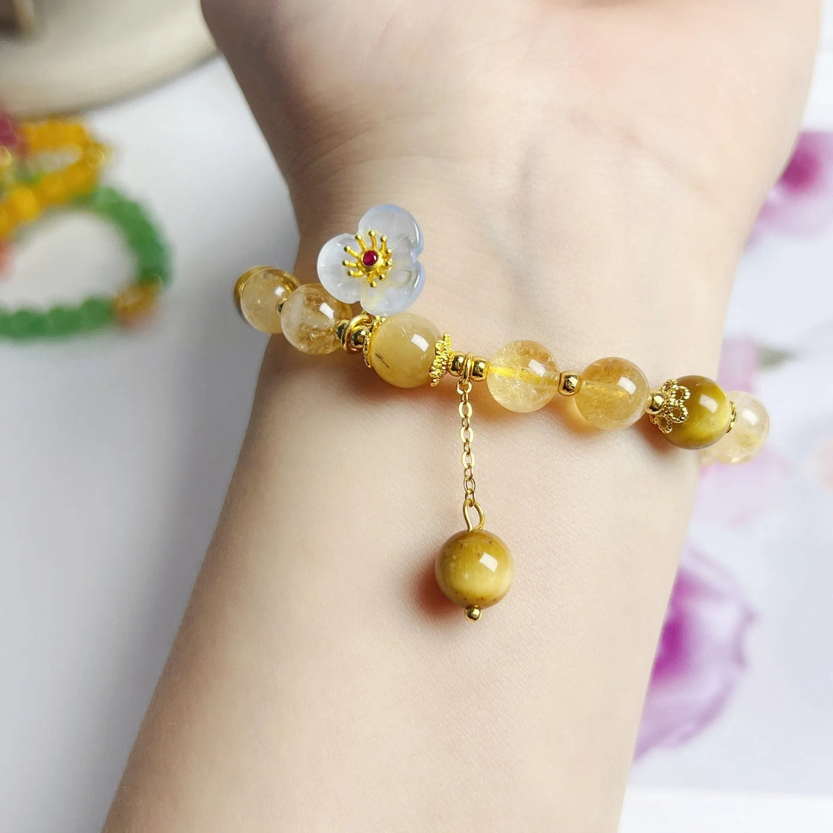 Citrine crystal bracelet with handmade flower tassel on wrist