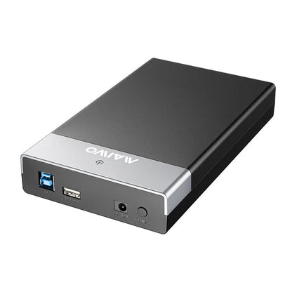 Black and silver 3.5-inch SATA hard disk enclosure with slide-open cover, USB 3.0 cable, and power adapter.