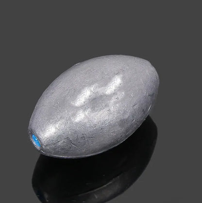 Rugby-shaped lead fishing sinker with scaled texture and plastic core protection for sea fishing
