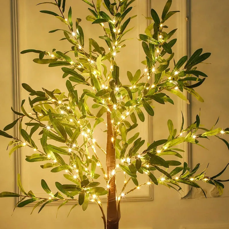1.8 metre tall artificial olive leaf tree lamp with warm white LED lights in courtyard setting