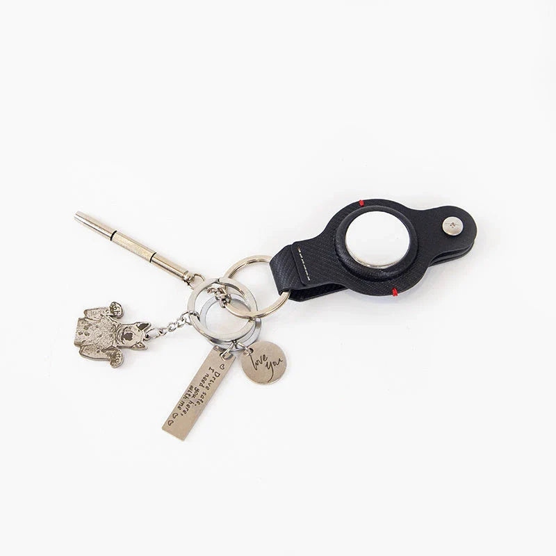 Stylish and secure AirTag holder keychain in black and grey PU leather, with a sturdy key ring for attaching to valuables