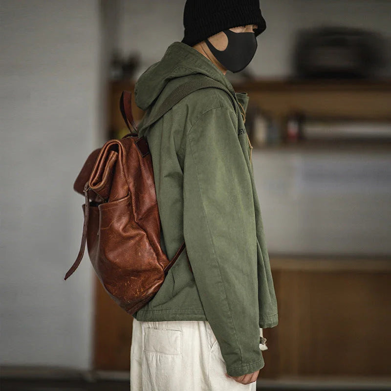 Rugged military-style hooded jacket for men made of durable cotton fabric with wind-resistant features and classic design