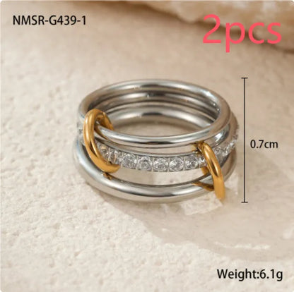 Stacked stainless steel rings with 18K gold plating in three colour variations, exaggerated hand jewellery designs