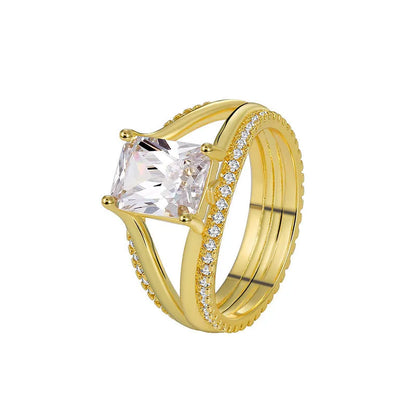 Gold electroplated geometric ring with a square zircon stone on a copper band.