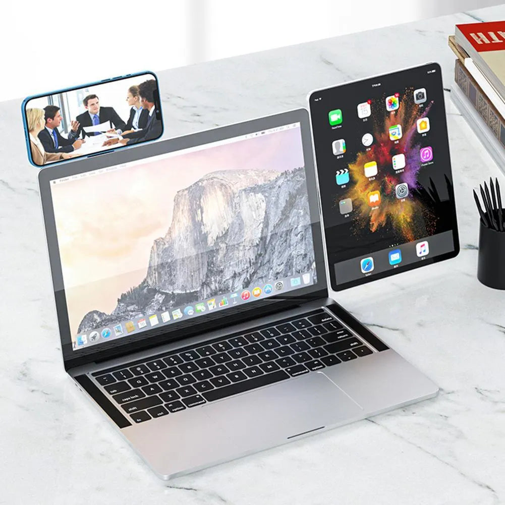 Black laptop phone holder with magnetic clip mounted on silver laptop, showing smartphone in adjustable bracket