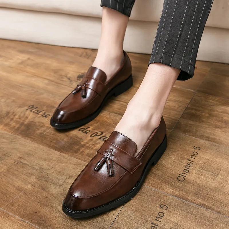 Men's black and brown business casual slip-on shoes with tassel detail and pointed toe