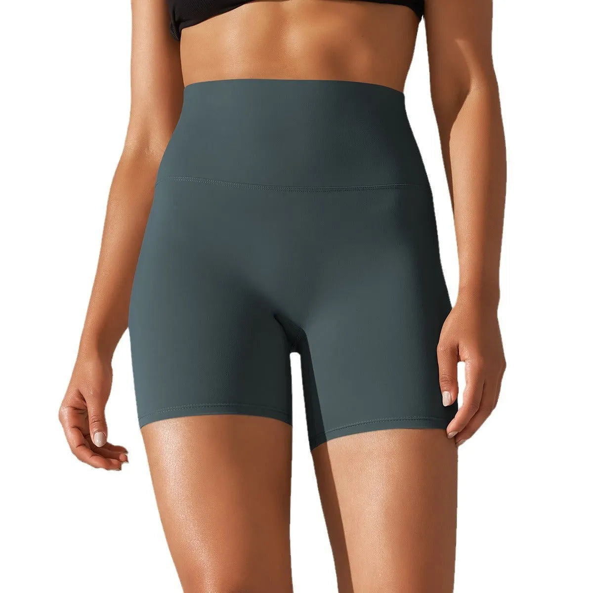 Woman wearing high waist hip lift fitness tights in a neutral colour, suitable for running or gym workout.