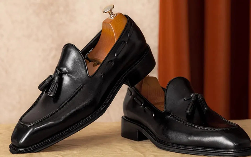 Men's black genuine leather slip-on loafers with polished finish and rubber sole