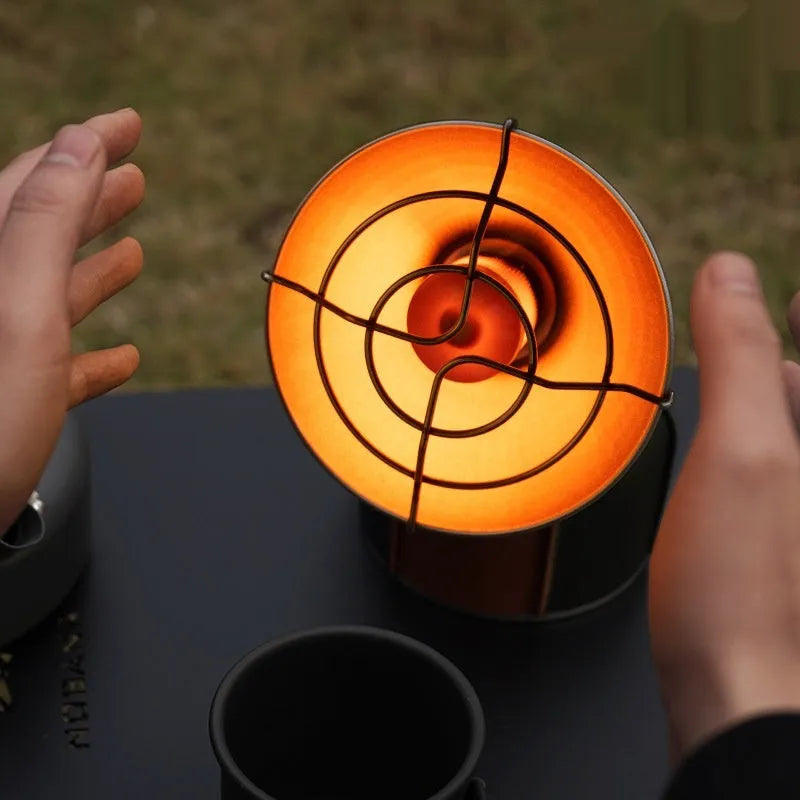 Black and orange portable outdoor heating stove with automatic press ignition for camping, weighing 215g