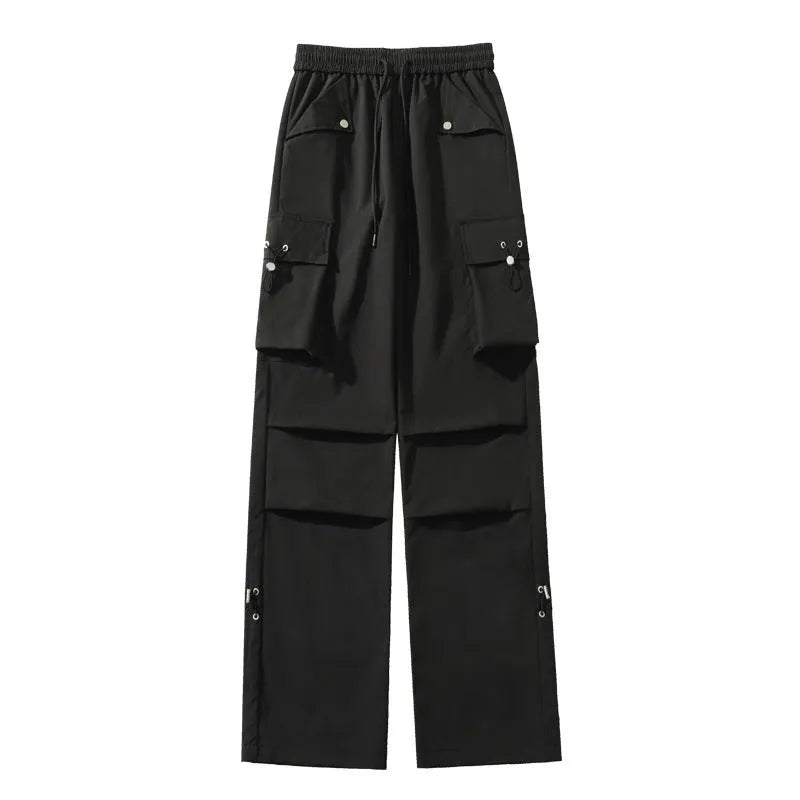Women's plus-size waterproof trousers in grey, showing straight-leg cut and drawstring waist.