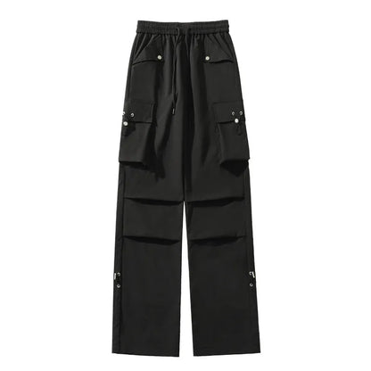 Women's plus-size waterproof trousers in grey, showing straight-leg cut and drawstring waist.