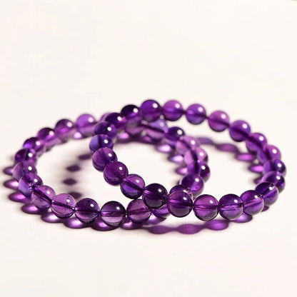 Natural amethyst scattered beads bracelet from Uruguay showing purple crystal beads in various sizes from 4mm to 16mm diameter