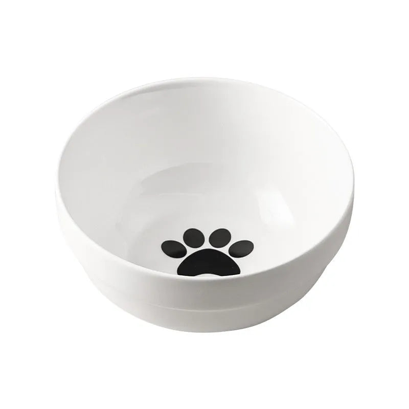 White ceramic pet bowl with cat paw design on a black iron frame raised feeder.
