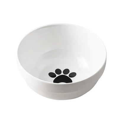 White ceramic pet bowl with cat paw design on a black iron frame raised feeder.