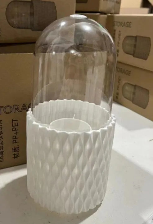 White rotating acrylic makeup brush holder with transparent dust cover on desktop