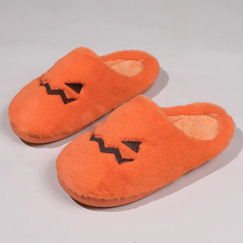 Cozy Halloween pumpkin-themed slippers with plush lining and non-slip soles for comfortable indoor wear