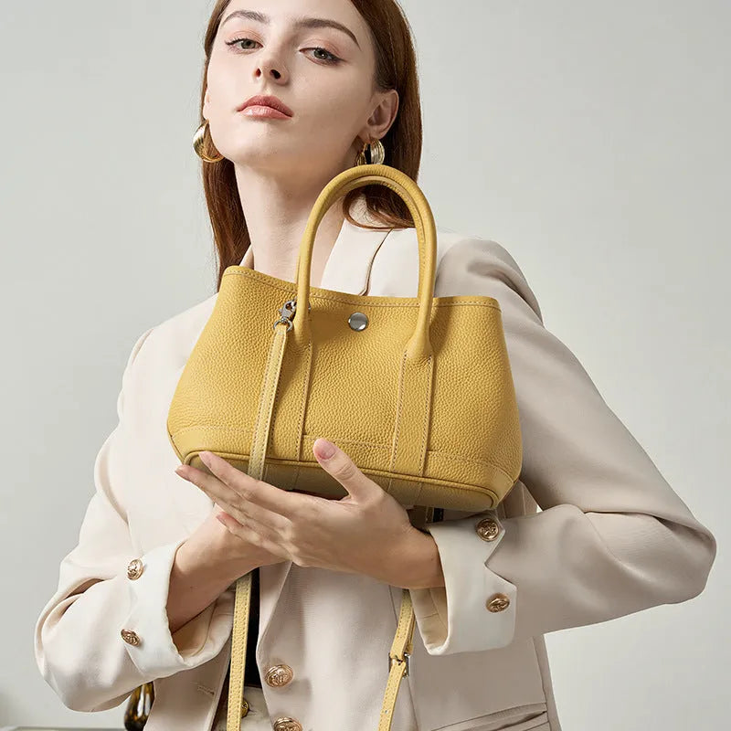 Genuine leather crossbody bag for women in first layer cowhide, horizontal square shape, single shoulder strap, shown in chicken yellow