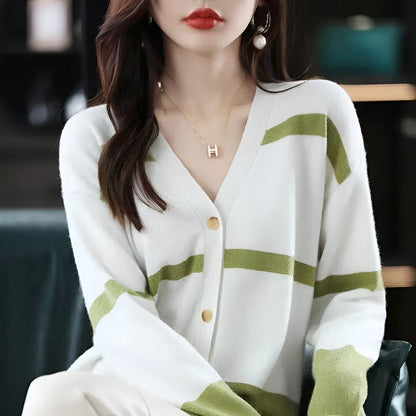 Women's black and white striped V-neck cardigan with buttons, showing a textured 3D knit pattern.