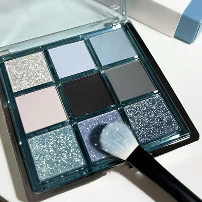 Low saturation blue smoked eye shadow palette with nine colours including matte and shimmer finishes with diamond debris textures