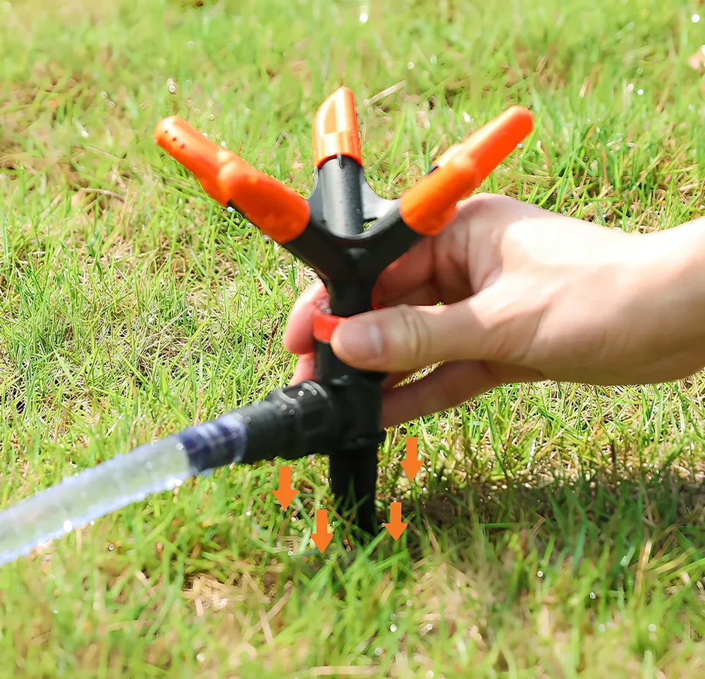 Orange automatic rotating garden sprinkler measuring 14cm diameter x 26.5cm height