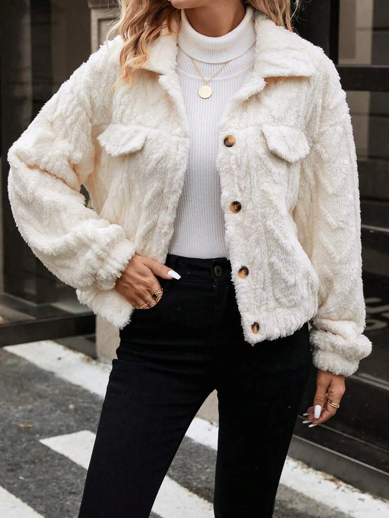 Ivory white women's double-sided plush button-front cardigan coat on a hanger.