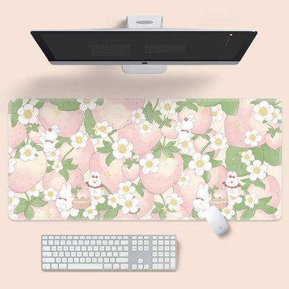 Large floral pattern mouse pad on a wooden desk with a computer mouse.