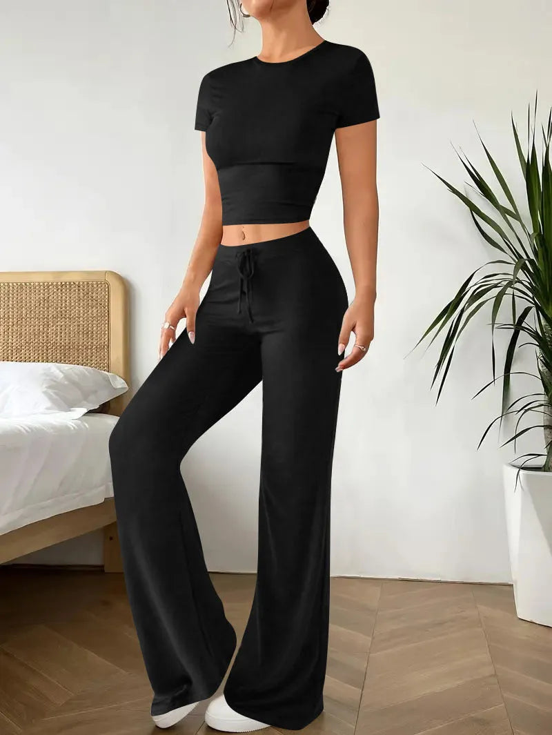 Black high waist trousers and regular sleeve t-shirt suit set on a model, showing the coordinated two-piece outfit