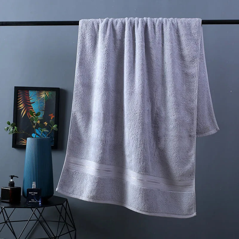 Three-piece cotton towel set showing bath towel, towel, and square scarf in coordinating colours