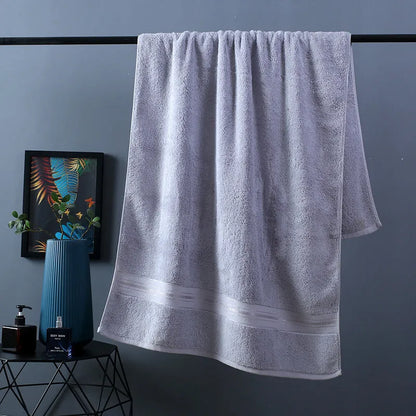Three-piece cotton towel set showing bath towel, towel, and square scarf in coordinating colours