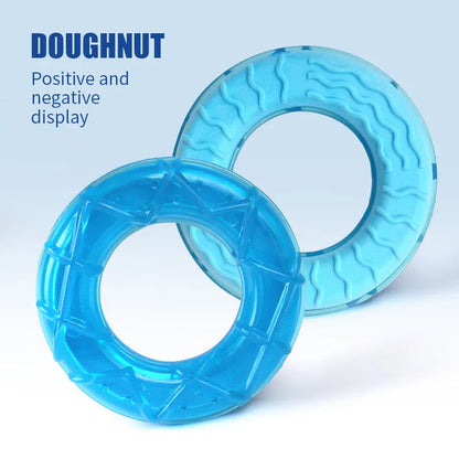 Three plastic dog toys: a blue pacifier, a red popsicle and an orange ring, designed to be filled with water and frozen.