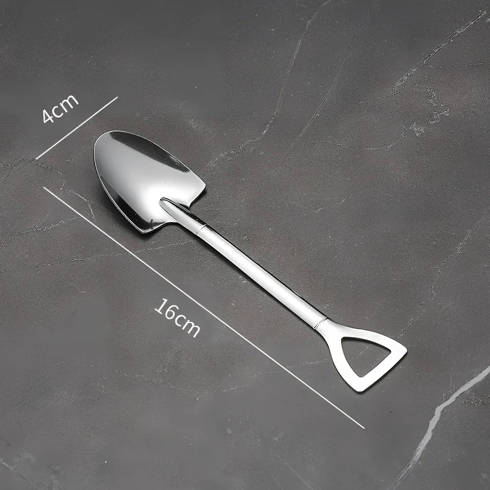 Orange ceramic Halloween pumpkin mug with cartoon face and included spoon on autumn table