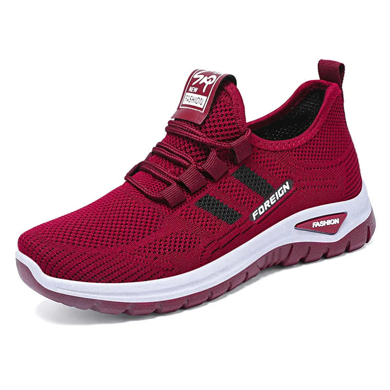 Low-top casual shoes with mesh upper and flat PVC sole in black, grey, purple, or red.