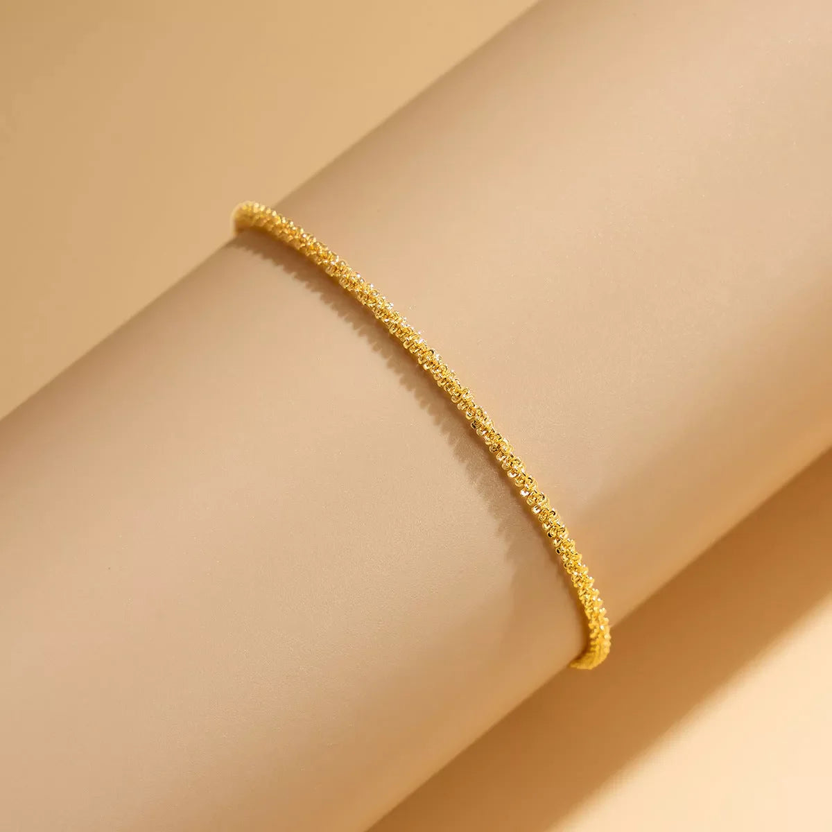 Slim chain metallic anklet in gold and white with wave design