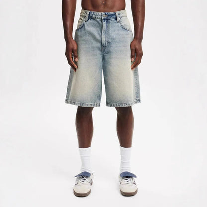 Men's light blue loose-fit straight-leg cotton jeans on a neutral background.