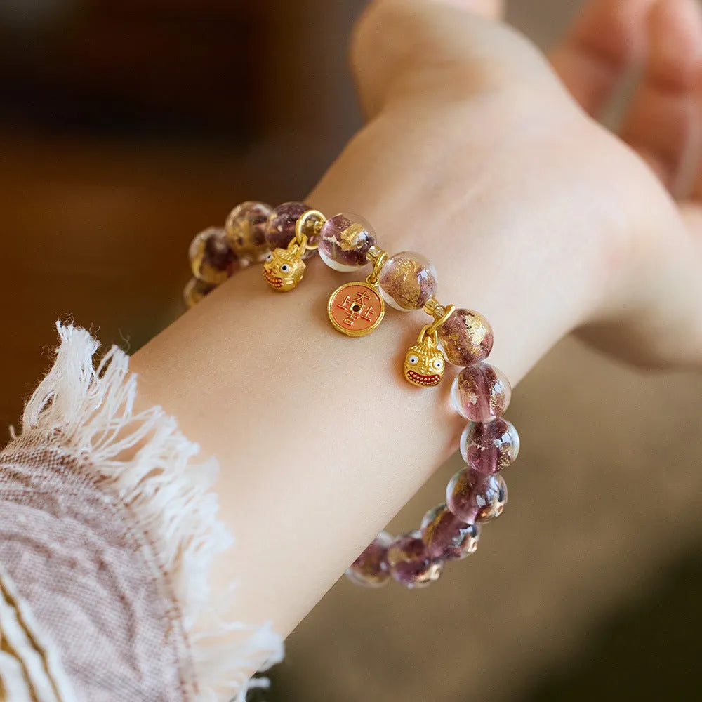 Handmade national style bracelet with coloured glaze swallowing gold beast charm on beaded band.