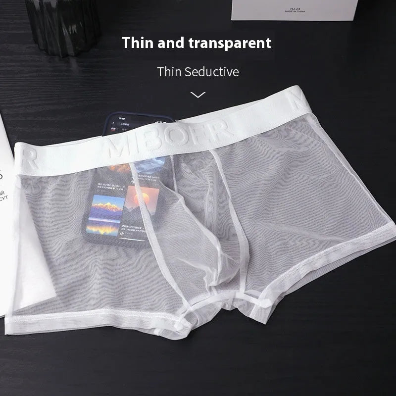 Men's thin knit boxer shorts in black, laid flat to show seamless design and waistband.