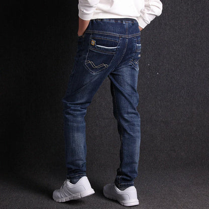 Boys' black micro-stretch cotton jeans showing 4-way flexibility and middle waist design