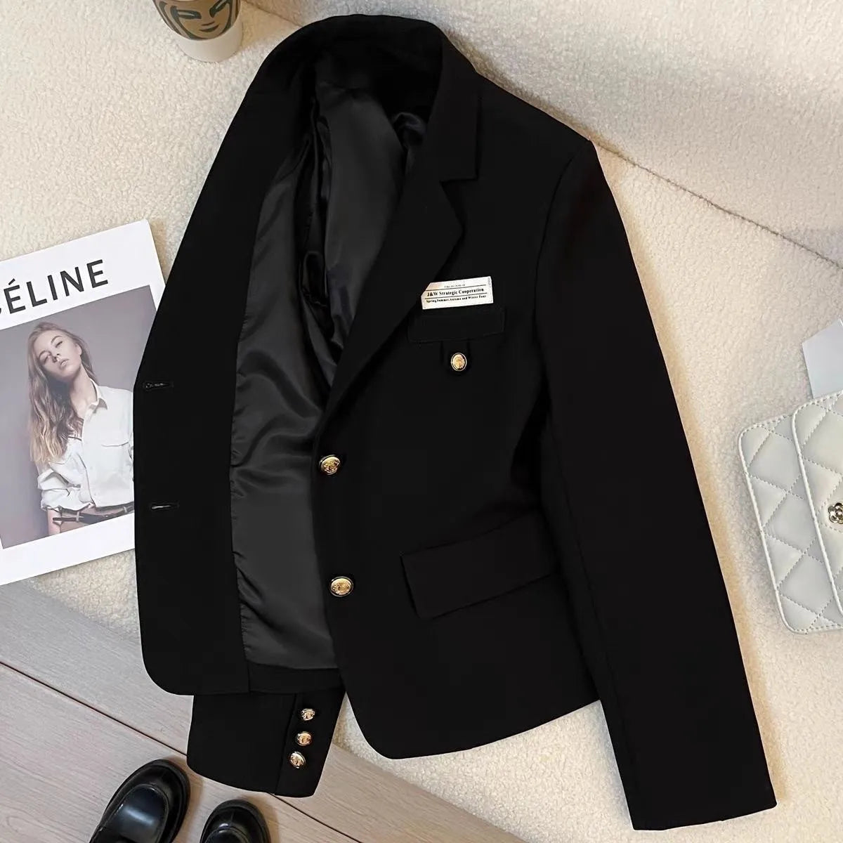 Black loose-fit women's short coat with long sleeves and pockets for college or commute wear.