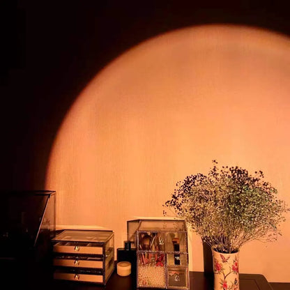 Rechargeable rainbow and sunset projection lamp with USB cable and push-button switch.